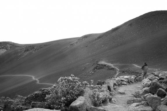 Desalentado, olhando a trilha que não iria fazer, em meio à encosta do vulcão Haleakala, em Maui, no Havaí